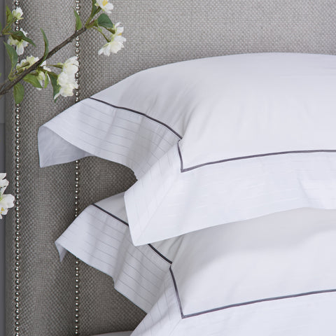 Heirlooms luxurious Sandringham cotton sateen white Oxford Pillowcase set with a contrast border whose subtle self colour woven stitch adds shien to your lines.